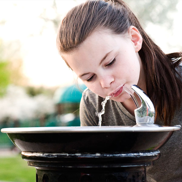 Girl at water fountain