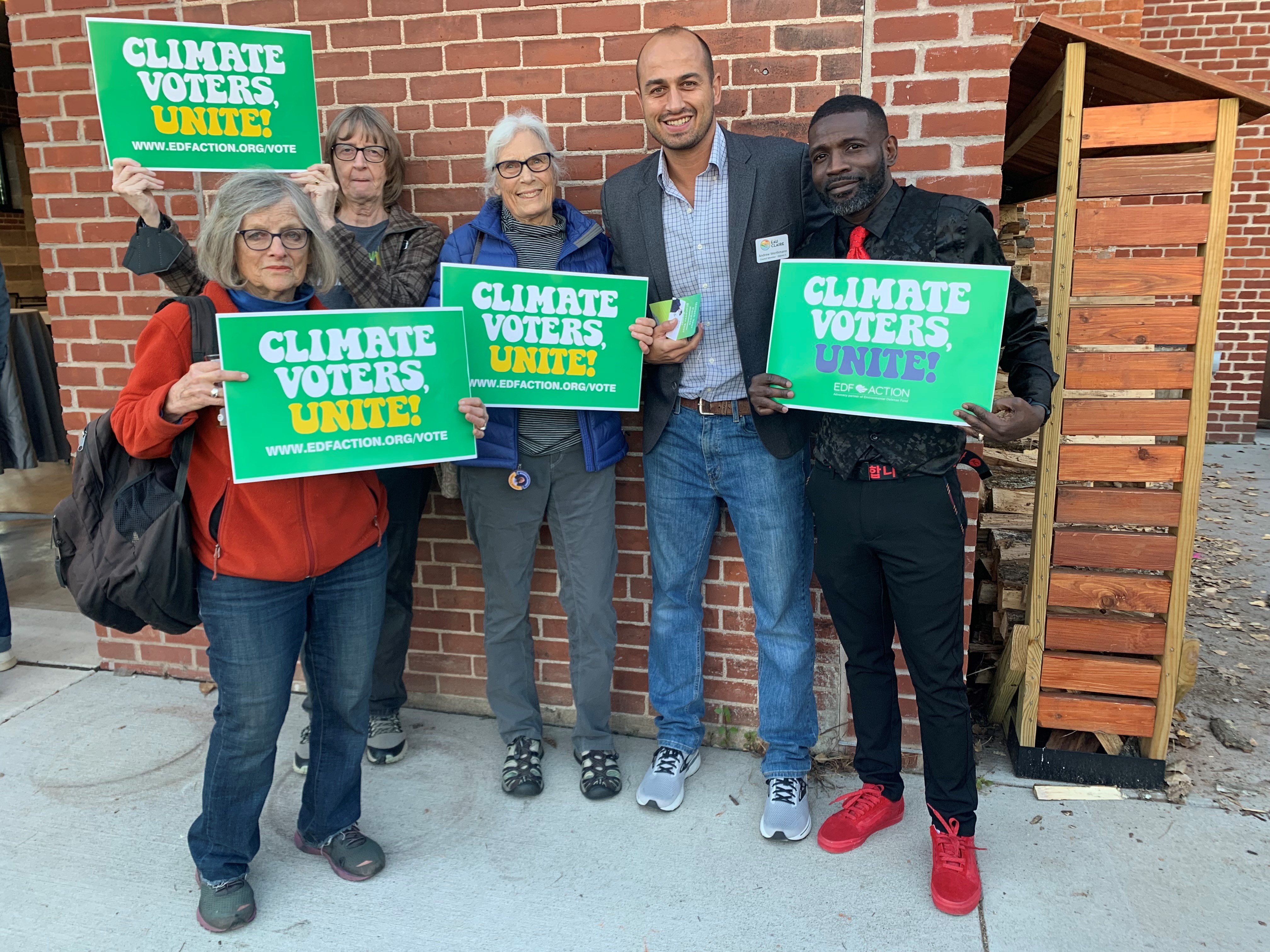 Five People Hold "Climate Voters, Unite!" Signs