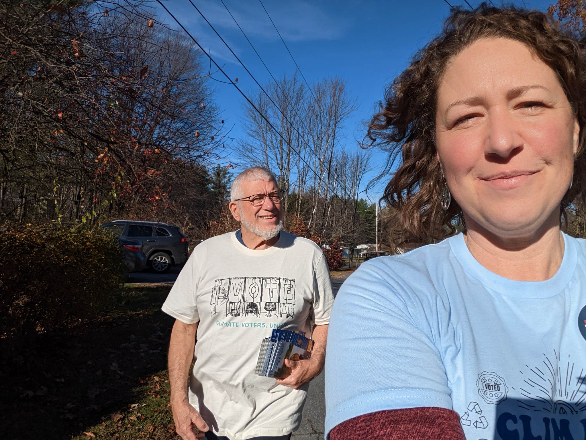 Two People Wearing EDF Action Shirts Pose for a Selfie in Claremont, NH.