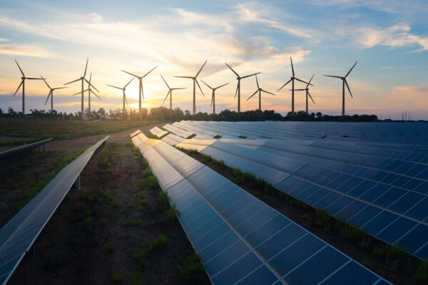 Solar panels and wind turbines generating renewable energy for green and sustainable future.