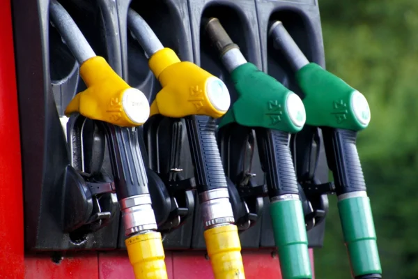 Yellow and green gas pumps lined up in their holsters.
